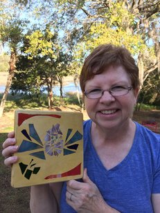 Carolyn Jenkins holding Stained Glass Garden Stepping Stone She made in Beginner's Workshop